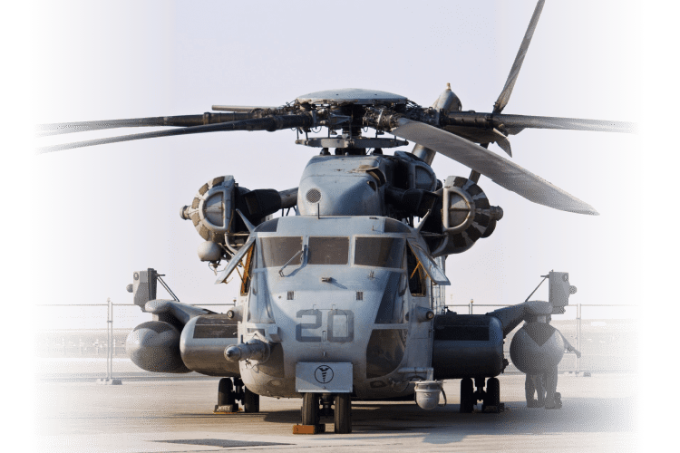 MH-52 Pave Low helicopter sitting at a military base helipad.